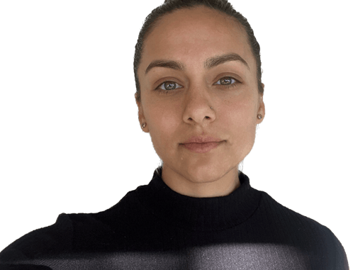 Woman with pulled-back hair and a black turtleneck, facing the camera against a plain background.
