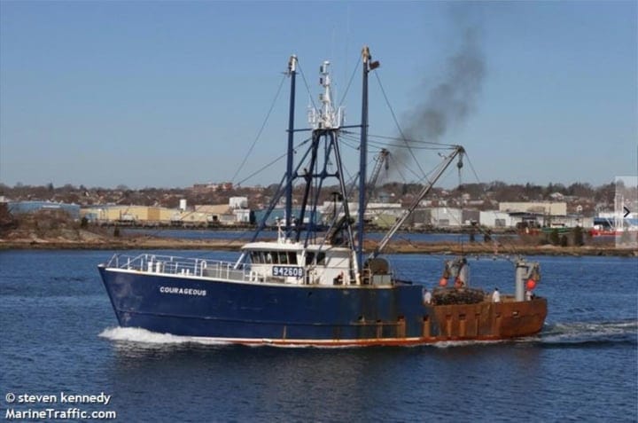 blue and white fishing vessel departing harbor with nets and equipment on deck against industrial cityscape background